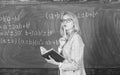 Principles can make teaching effective. Woman teaching near chalkboard in classroom. Effective teaching involve