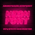 Red neon alphabet font. Neon color light bulb oblique letters and numbers. Royalty Free Stock Photo