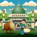 Muslim boy with a sheep in front the mosque