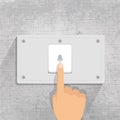 Doorbell. finger pressing Doorbell button in gray background Royalty Free Stock Photo