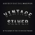 Vintage Silver alphabet font. Beveled messy letters and numbers on distressed background. Royalty Free Stock Photo