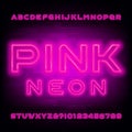 Pink neon alphabet font. Light bulb retro letters and numbers on a brick wall background. Royalty Free Stock Photo