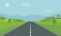 Straight empty road through the countryside. Green hills, blue sky, meadow and mountains. Royalty Free Stock Photo