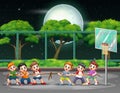 Group of boys playing tug of war on the court at night Royalty Free Stock Photo