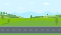 Straight empty road through the countryside. Green hills, blue sky, meadow and mountains. Royalty Free Stock Photo