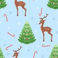 Cute cartoon deer, christmas trees, candies and snowflakes on blue background. Festive winter seamless pattern. Royalty Free Stock Photo