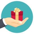 Red gift box with golden bow in man`s hand. Surprise vector illustration in cartoon simple flat style. Royalty Free Stock Photo