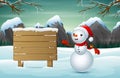 A cute snowman and a snowy wooden sign Royalty Free Stock Photo