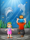 Father and children watching fishes at aquarium excursion Royalty Free Stock Photo