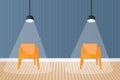 Two chairs far apart under spotlight in room Royalty Free Stock Photo