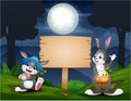 Happy easter bunnies with wooden blank sign in the forest Royalty Free Stock Photo