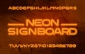 Neon alphabet font. Orange neon color letters and numbers. Abstract background. Royalty Free Stock Photo