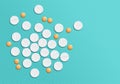 White and orange pills on textured background. Royalty Free Stock Photo