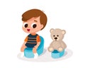 Boy sitting with teddy bear. Potty training.