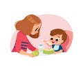 Mom feeding baby boy. Healthy food.