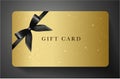 Gift card with twinkling stars, sparkling elements and back bow ribbon on gold background Royalty Free Stock Photo