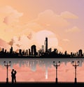 Silhouetted young lovers with city background