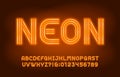 Neon alphabet font. Yellow neon light letters and numbers in 70s style. Blurred background.