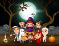 Happy kids in different costumes on Halloween night party