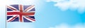 UK flag waving on a blue sky background. Royalty Free Stock Photo