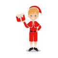 Cute blonde boy holding a gift while wearing Christmas costume.