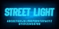 Street Light alphabet font. Blue neon light letters and numbers. Brick wall background. Royalty Free Stock Photo