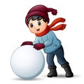 Cute little boy in winter clothes playing a snowball Royalty Free Stock Photo