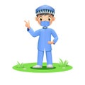 Cute Muslim boy in face mask pointing his finger up Royalty Free Stock Photo