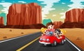 The family traveling by red car through the desert