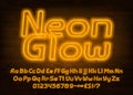 Neon Glow alphabet font. Yellow neon light letters, numbers and punctuation. Royalty Free Stock Photo