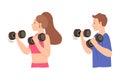 Fit man and woman working out  using dumbbells. Royalty Free Stock Photo