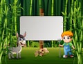 Young farmer and a donkey standing near the blank sign Royalty Free Stock Photo