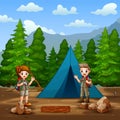 The scout boy and girl camping in the forest