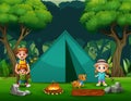 Happy father and children camping in the forest