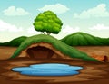 Empty underground animal hole with a small pond