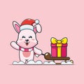 Cute christmas bunny rabbit carrying gift box cartoon vector illustration. Royalty Free Stock Photo