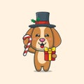 Cute dog holding christmas candy and gift Royalty Free Stock Photo