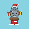 Cute hippo with santa hat in the chimney Royalty Free Stock Photo