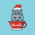 Cute hippo wearing santa hat in cup Royalty Free Stock Photo