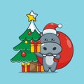 Cute santa hippo carrying christmas gift Royalty Free Stock Photo