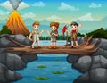 Scouts crossing the river on the tree trunk bridge Royalty Free Stock Photo