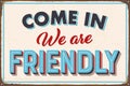 Come in we are friendly vintage style rusty metal sign. Royalty Free Stock Photo