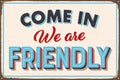 Come in we are friendly metal sign Royalty Free Stock Photo