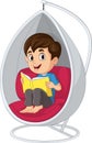Little boy reading a book in hanging chair Royalty Free Stock Photo