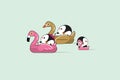 Relaxing cute penguins couple floating in flamingo and swan inflatable swimming pool toy on sea shore at sunny summer day