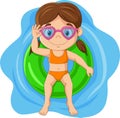 Cute little girl with swimsuit and glasses lying on inflatable ring Royalty Free Stock Photo