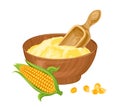 Corn flour in wooden bowl with spoon and yellow maize.