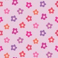 Cute retro 70s simple flowers seamless pattern in pink, red, orange and purple on light pink background. Royalty Free Stock Photo