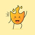 cute fire cartoon with smile and happy expression. close eyes and one hand up Royalty Free Stock Photo
