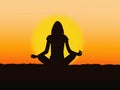 Silhouette of a young woman meditating yoga at sunrise or sunset Royalty Free Stock Photo